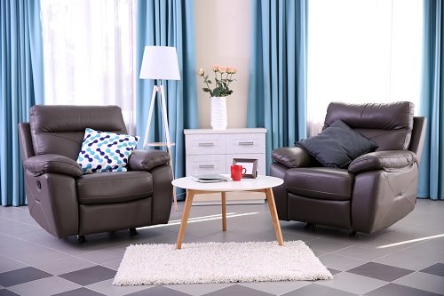 Modern living room interior with coffee table, two large recliners